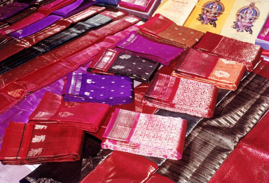Sell old silk sarees in South Bangalore with doorstep buyer evaluating sarees